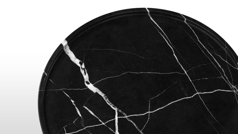 Refined Presence | The polished black marble not only enhances the table's aesthetic appeal but also imparts a sense of luxury and sophistication. The smooth and reflective surface of the marble adds a touch of opulence to the Roc Side Table, making it a focal point in any space.
