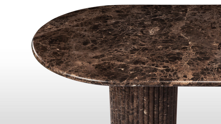 NATURAL MARBLE | Made from polished Italian Dark Emperador marble, this beautiful contemporary table makes a stunning centrepiece. Featuring a moon-like oval top and a reeded pedestal base, it is a great choice for considered, modern homes.
