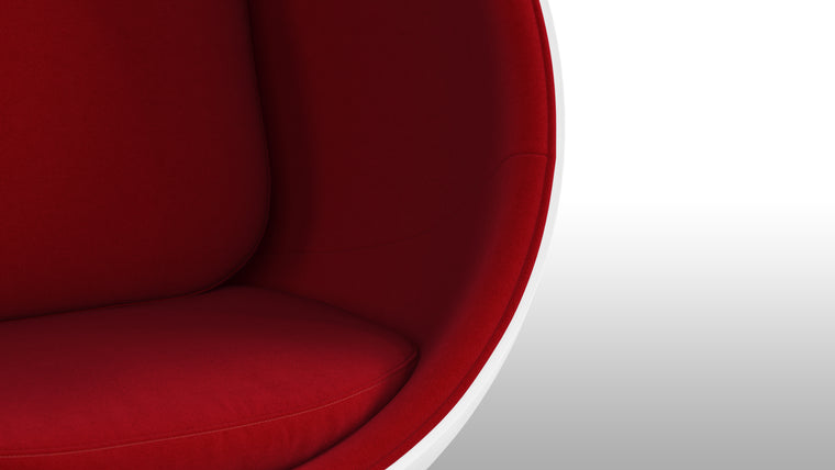 Color Contrast|Inside its white half-sphere, this unique chair features vibrant upholstery for a beautiful pop of color.
