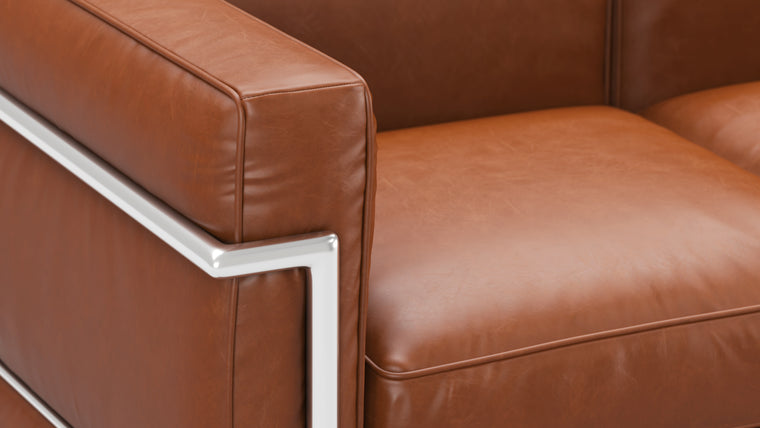 Sleek Frame | The iconic tubular frame design is instantly recognizable and adds a touch of architectural elegance to your space. It not only provides exceptional stability, but also complements the leather upholstery with its polished, minimalist aesthetic. 
