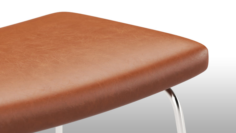 Stylish Stool|The ottoman's versatile design extends beyond being a footrest. It can also double as an extra seat or a convenient surface for holding books, trays, or decorative items. Its sturdy base ensures stability, making it a functional and practical addition to any living space.
