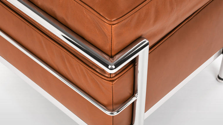 Sleek Frame | The Corbusier Ottoman boasts a sturdy and sleek stainless steel frame, which not only provides exceptional stability but also complements the leather upholstery with its polished, minimalist aesthetic. The iconic tubular frame design is instantly recognizable and adds a touch of architectural elegance to your space.
