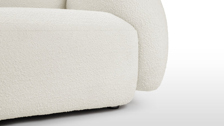 Boucle Beauty | The Gigi Sofa goes beyond mere aesthetics by incorporating high-quality materials and expert craftsmanship, ensuring longevity and enduring beauty. The premium upholstery adds a touch of opulence to this already exquisite piece. Its sturdy construction and attention to detail speak to a commitment to both form and function, making the Gigi Sofa a lasting investment in comfort and style.

