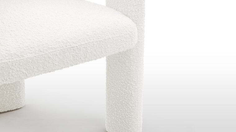 Contemporary Elegance | Draped in luxurious white bouclé fabric, the Adele Chair takes on an air of sophistication and modernity. The tactile allure of bouclé adds a layer of comfort and opulence, while the choice of white ensures a timeless and versatile appeal that seamlessly integrates into various design schemes.
