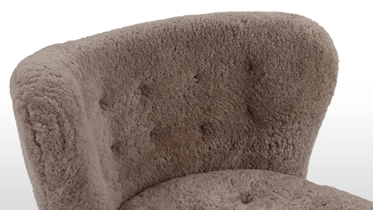 CONSTRUCTED FOR COMFORT | Cocooned in luxurious sheepskin, the Petra Chair offers an exceptionally cozy and comfortable lounging experience.
