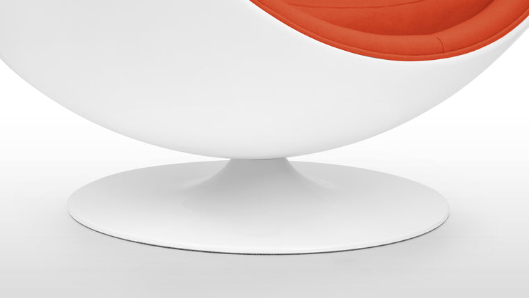 COLOR CONTRAST | Inside its white half-sphere, this unique chair features vibrant upholstery for a beautiful pop of color.
