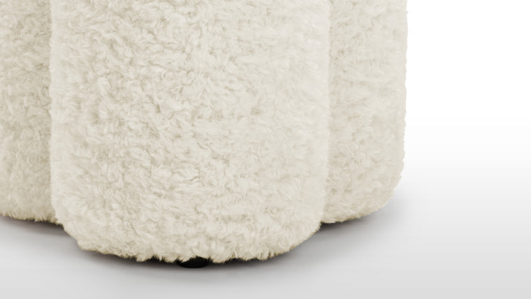 Nature Inspired | The Pia Ottoman’s rounded form takes on an organic shape. Upholstered in a low maintenance, faux sheepskin, its fluffy texture evokes the inviting softness of natural fleece, bringing a touch of the outdoors inside.
