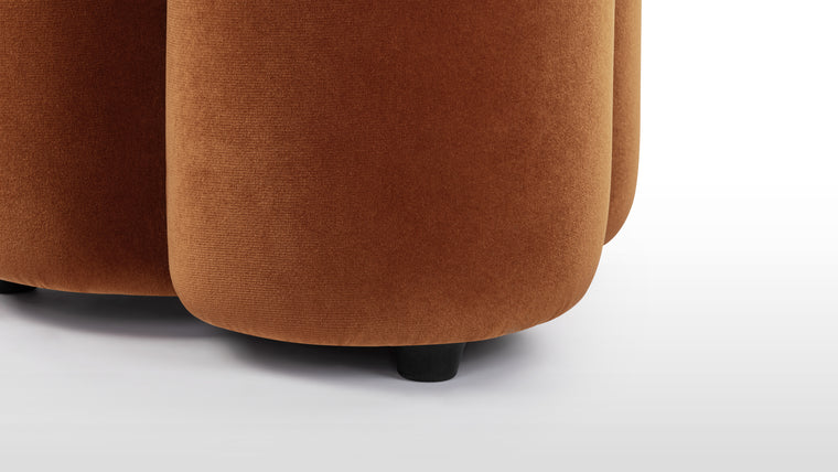 Nature Inspired | The Pia Ottoman’s rounded form takes on an organic shape. Upholstered in a low maintenance, burnt orange velvet, its deep copper hue evokes the warmth of sunsets, bringing a touch of the outdoors inside.
