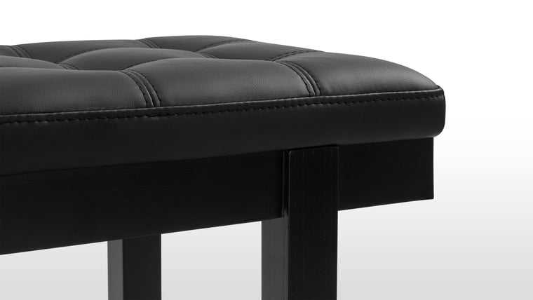 Considered Upholstery | Featuring expert upholstery, with button detailing and double seams dividing each cushion into squares, reminiscent of iconic modernist designs. The ash wood frame, finished in matte black paint, provides a sleek and sturdy foundation.
