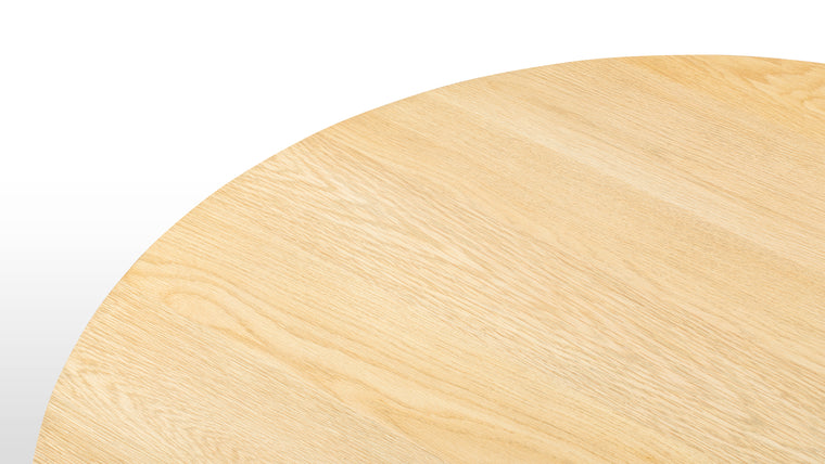 Harmonious Construction | Craft Crafted from high-quality oak, the Amalfi Round Dining Table highlights a beautiful grain that enhances its visual appeal. The light-colored finish preserves the wood's natural look, ensuring durability and a pristine aesthetic.
