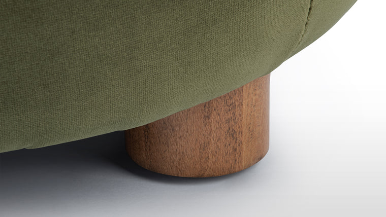 Inviting Piece | Crafted with high-quality rich green velvet and supported by warm-toned wooden feet, the Niner Ottoman combines luxurious fabric with natural materials for a refined yet inviting look.
