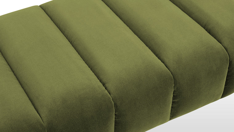 Velvet Luxury | Upholstered in rich, deep moss-colored velvet, this bench is designed with fluted panels across a wide seat and uniformly wrapped legs, ensuring a luxurious and cohesive look inspired by shades of green in nature.
