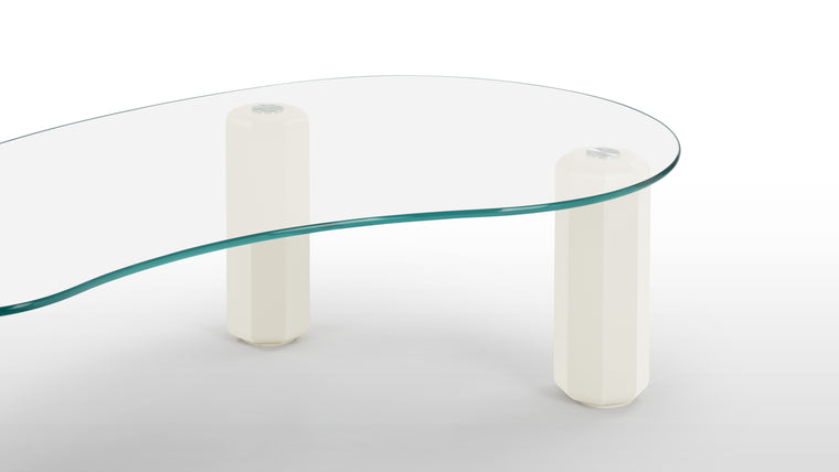 Functional Style | Wide legs paired with a thin glass surface, ensuring both functionality and style. The wave-like shapes and rounded edges to the tabletop contrast with its sturdy, commanding legs.
