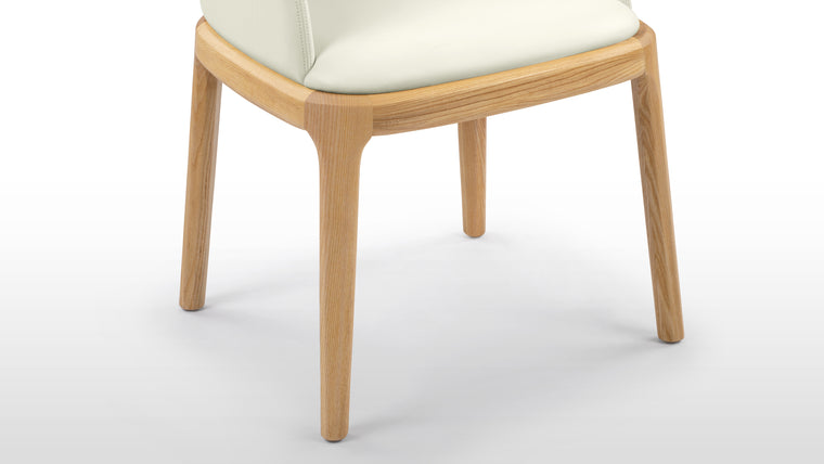 Enduring Comfort | Ergonomically curved for full body support and padded for long-lasting comfort, the design's versatile forms—side chair, armchair, or stool—make it an adaptable piece for various spaces.
