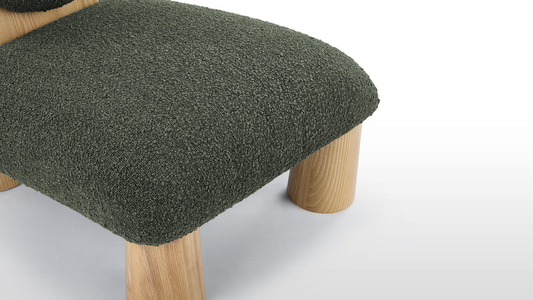 Colorful Tactility | Crafted with soft boucle fabric, natural wood legs, and generous foam padding, the chair offers a mix of comfort and sturdy construction. The combination of durable materials ensures both style and longevity.
