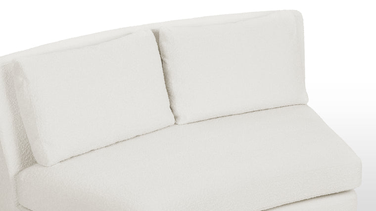 Textured Sophistication | Crafted from soft boucle fabric, the sectional exudes a tactile richness while maintaining a sleek European-inspired silhouette. The fabric’s warm white hue adds both comfort and contemporary visual appeal.
