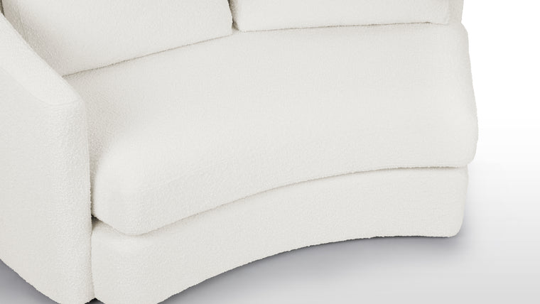 Textured Sophistication | Crafted from soft boucle fabric, the sectional exudes a tactile richness while maintaining a sleek European-inspired silhouette. The fabric’s warm white hue adds both comfort and contemporary visual appeal.
