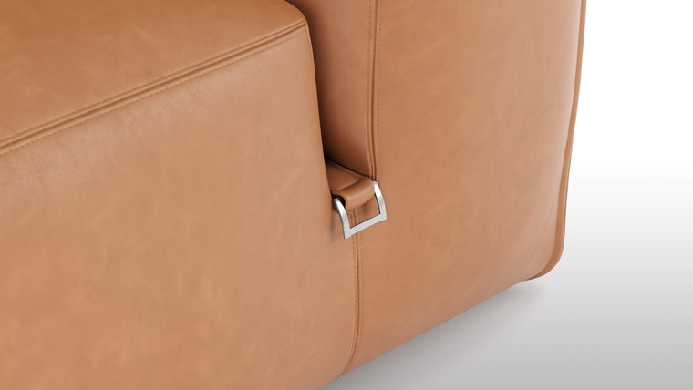 Premium Texture | Available in both neutral-toned fabric and leather or vegan suede, the collection features a foam interior for deep comfort, with understated wooden legs and sleek metal buckles for easy configuration.
