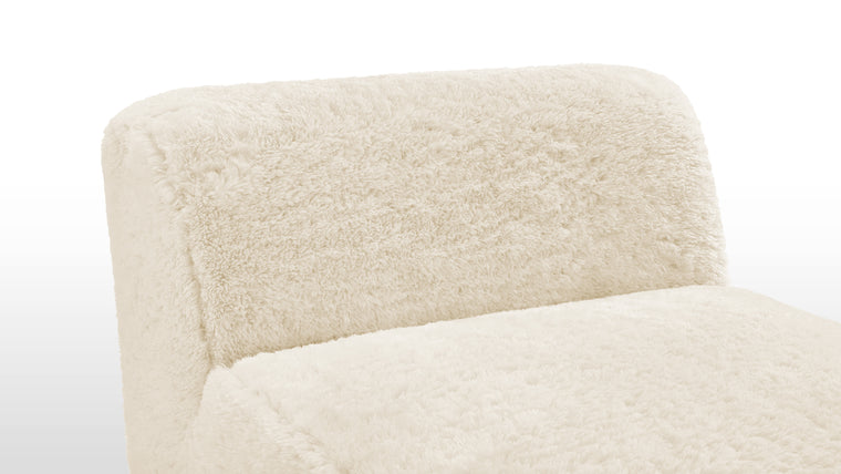 Material Harmony | Crafted with meticulous attention to detail, the Iona Sectional is upholstered in faux sheepskin, a soft and sumptuous material that not only feels luxurious but also radiates an inviting warmth. Its light cream tone adds an air of sophistication and minimalism, blending seamlessly with diverse décor styles.
