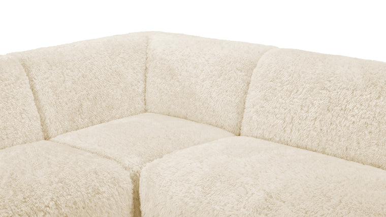 Material Harmony | Crafted with meticulous attention to detail, the Iona Sectional is upholstered in faux sheepskin, a soft and sumptuous material that not only feels luxurious but also radiates an inviting warmth. Its light cream tone adds an air of sophistication and minimalism, blending seamlessly with diverse décor styles.
