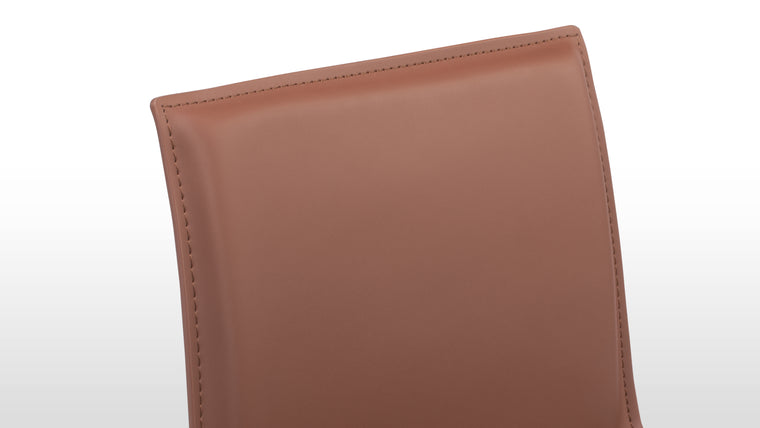 Premium Leather Upholstery | Enjoy the supple feel and enduring quality of top-grade leather that covers every inch of the stool, from seat to legs.
