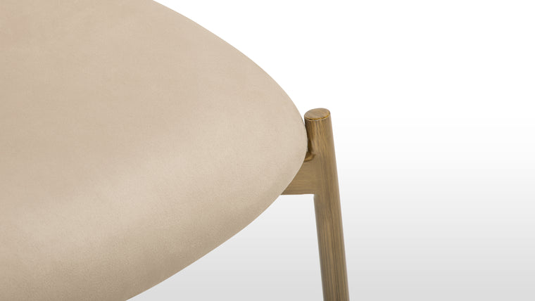 Sculptural Form | With clean lines and a slender silhouette, the brass frame doubles as functional art—its warm metallic finish providing just the right amount of contrast to the muted upholstery.
