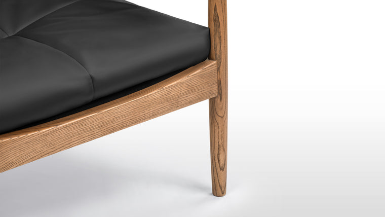 Crafted Comfort, Timeless Form | Crafted with solid wood framing and vegan leather upholstery, the chair is designed to develop warmth and character over time while aligning with conscious living and easy maintenance.
