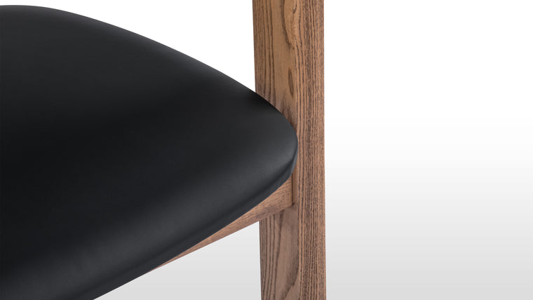 Comfort in Form | The gently curved backrest and integrated arms provide supportive comfort for long dinners or deep conversations. Its proportions allow you to sit with ease, while the open structure keeps the chair visually airy.
