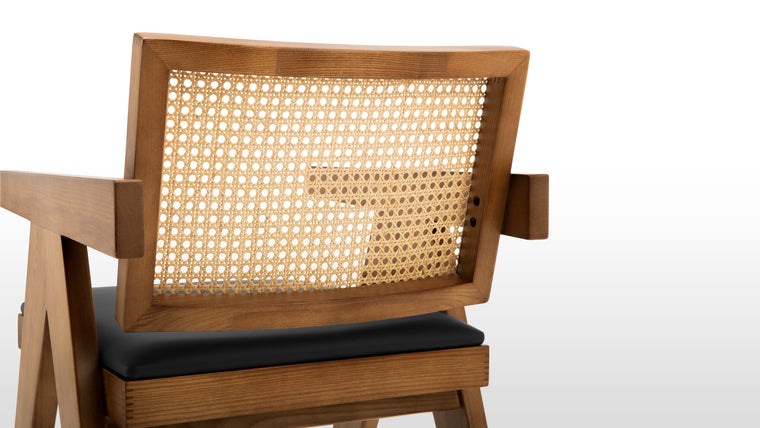 STYLISH SPECIFICS | Proving that beauty is in the details, the Pierre Jeanneret Dining Chair boasts an upholstered seat and rattan back that is meticulously handmade by talented artisans.
