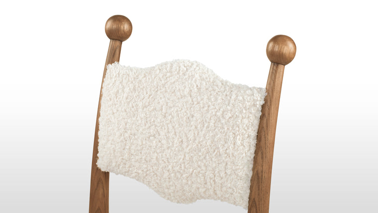 A Soft Statement | Finished in warm, natural tones, the Boheme Chair adds a touch of understated luxury, enhancing your dining space with a welcoming, lived-in beauty that invites daily use.
