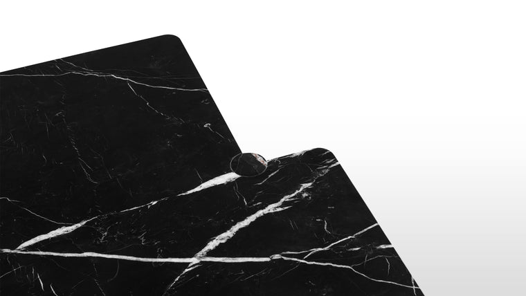 Sculpted in Stone | Cut from Nero Marquina marble, each table showcases a unique tapestry of crisp white veins against a deep black ground, creating a monolithic visual that is both grounding and luxurious.
