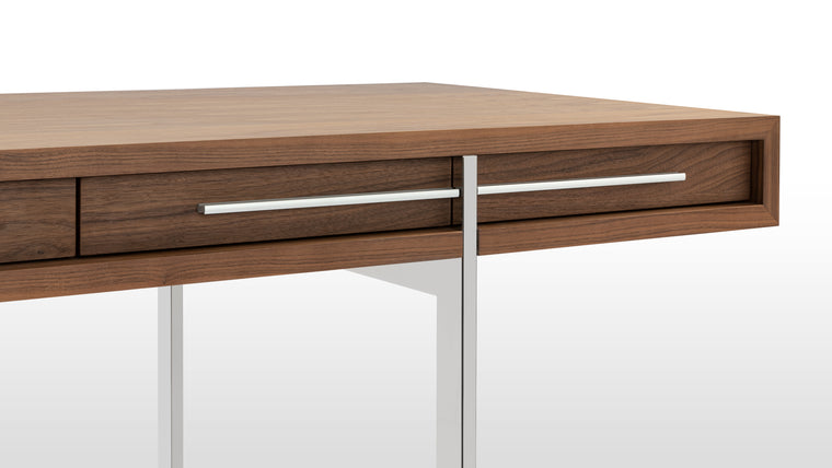 Stylish Details | In addition to a natural, walnut veneer, the Naver Desk features stainless steel legs that are beautifully integrated into the desk’s form. It’s an open, airy base that helps lighten the overall look. 
